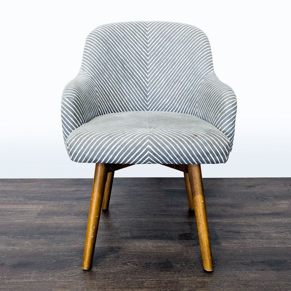 Grey and white striped lounge chair with curved back, wooden swivel legs, and modern West Elm style.