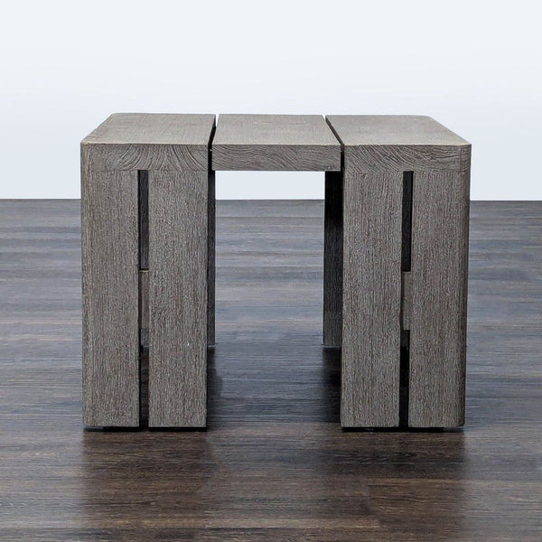 Modern block side table by Restoration Hardware with slatted top and weathered teak finish, shown from the front.
