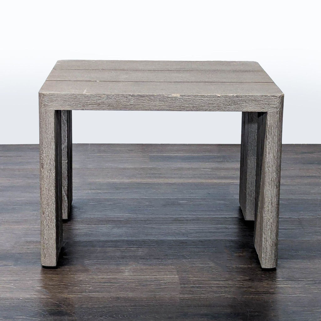 Minimalist teak side table from Restoration Hardware, displaying sturdy slatted design and neutral finish, front view.