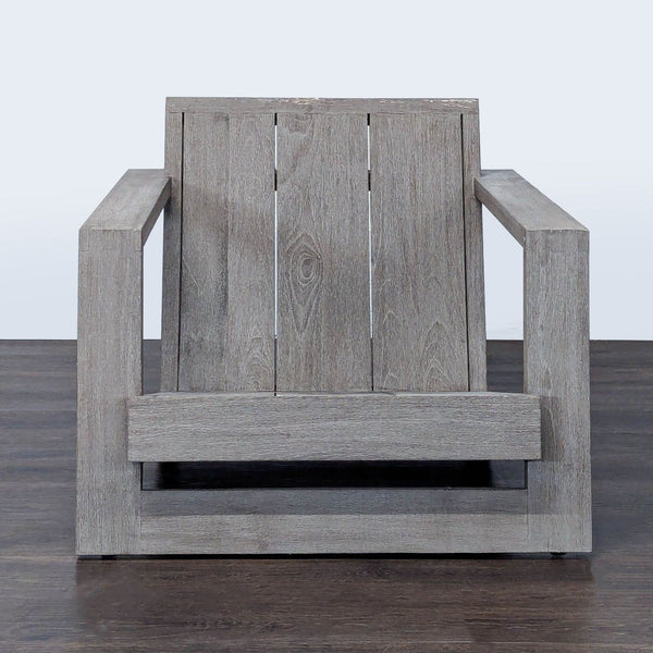 Modern Restoration Hardware chair with teak frame, wide armrests, and geometric design; fits living or patio spaces.  