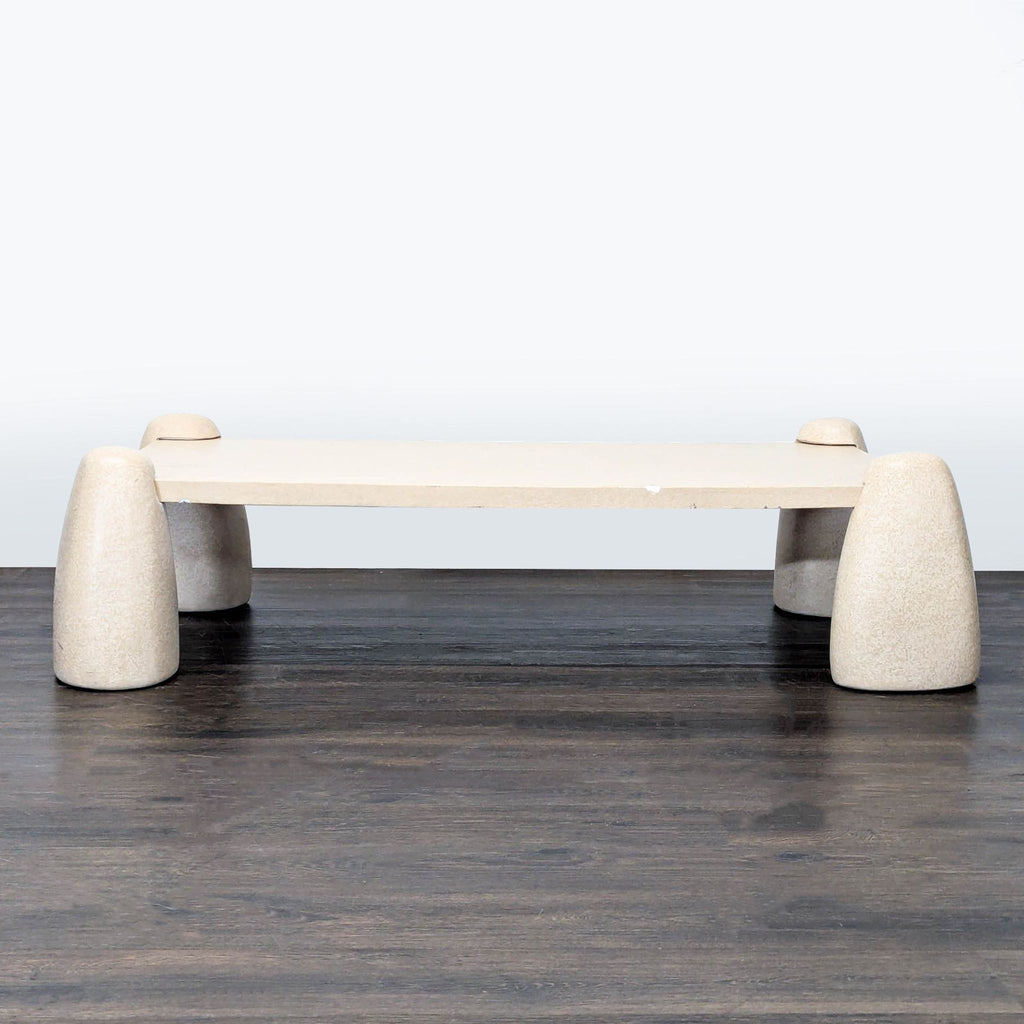 Concrete coffee table with sculptural, boulder-inspired legs and clean, sand-finished top by Lulu And Georgia.
