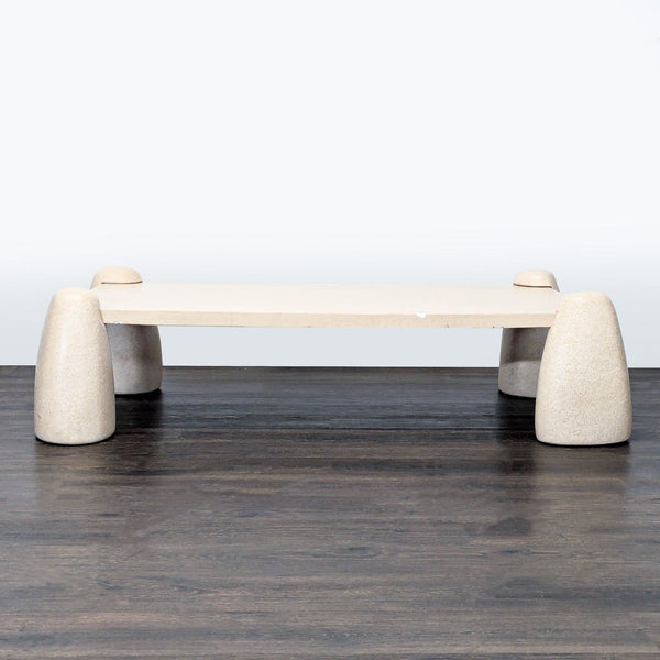 Concrete coffee table with sculptural, boulder-inspired legs and clean, sand-finished top by Lulu And Georgia.
