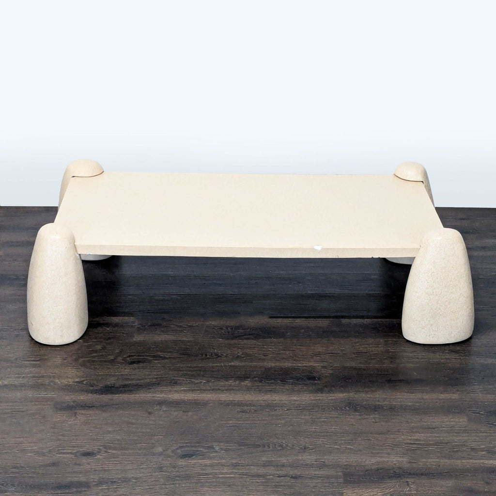 Lulu And Georgia Quarry Coffee Table with unique stone-like base and minimalist rectangular top in sandy finish.