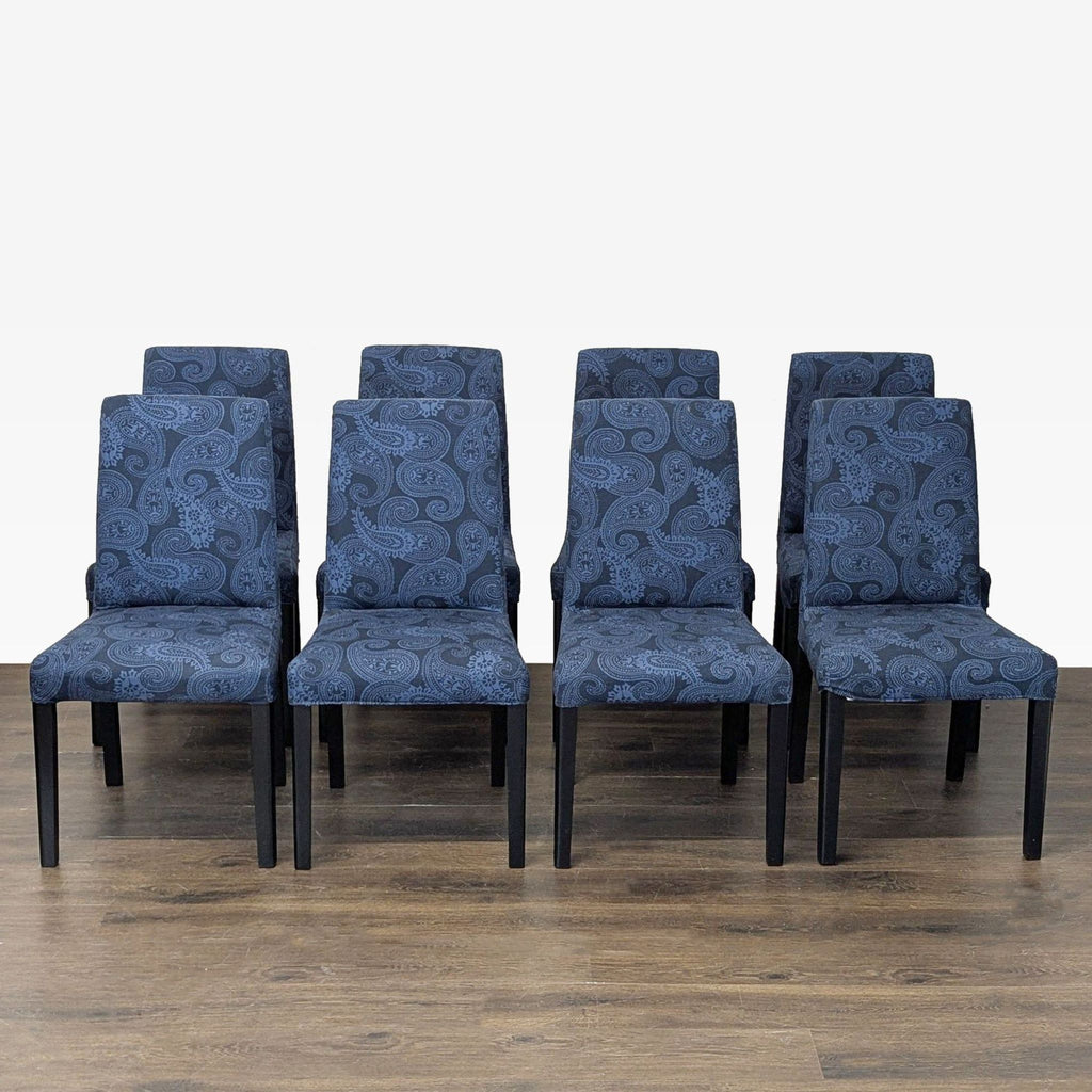 Pair of Parsons-style dining chairs with paisley fabric upholstery and wooden legs by Ikea.