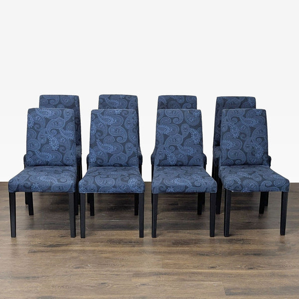 Pair of Parsons-style dining chairs with paisley fabric upholstery and wooden legs by Ikea.