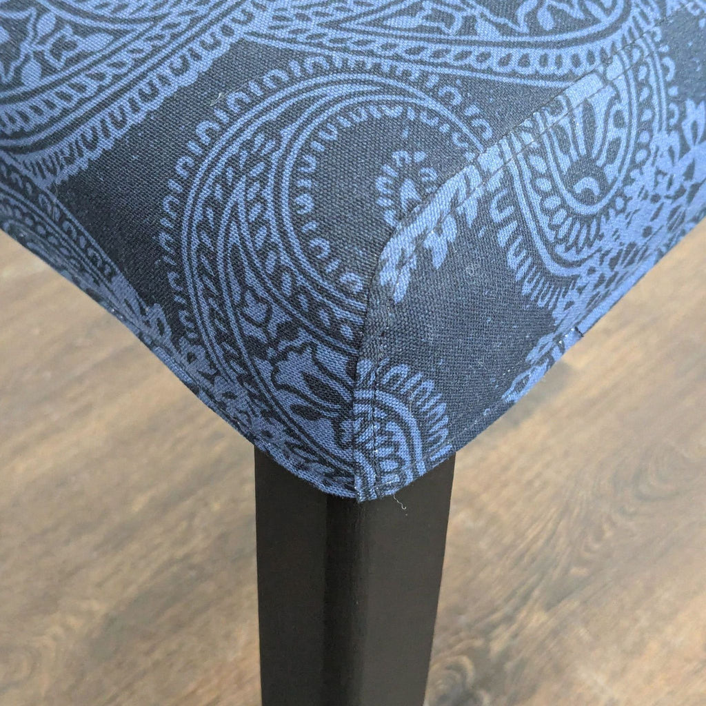 Set of Ikea dining chairs featuring paisley patterned upholstery and classic wood legs.
