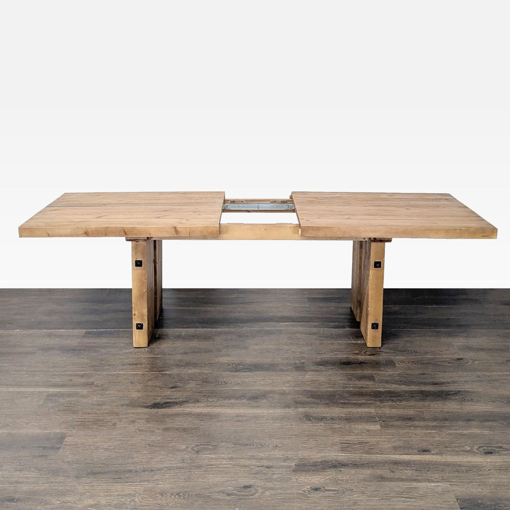 Natural-finish recycled wood table by Pottery Barn, featuring metal accents and spacious extension leaf.