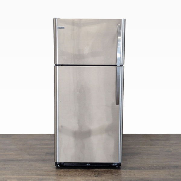 Frigidaire stainless steel refrigerator with top freezer, compact size, easy-grip handles, and organized storage.