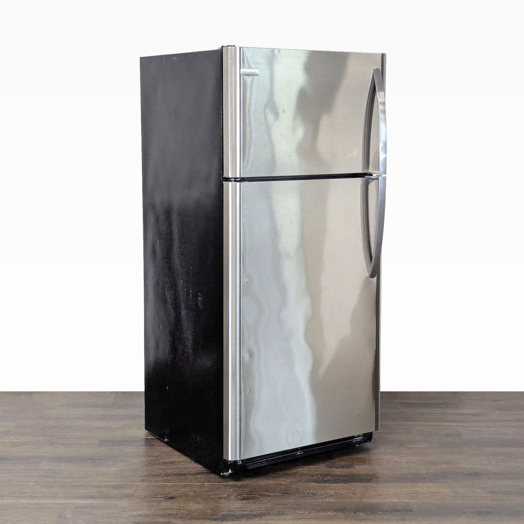 Sleek Frigidaire fridge, top freezer style, stainless steel finish, ideal for apartments or office kitchens.