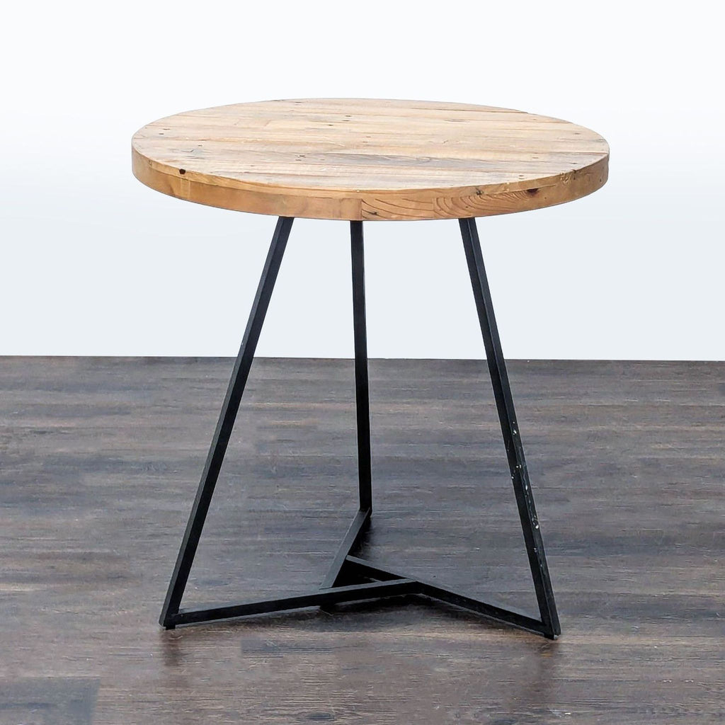 Dining table featuring a reclaimed pine tabletop and metal legs, by West Elm.  