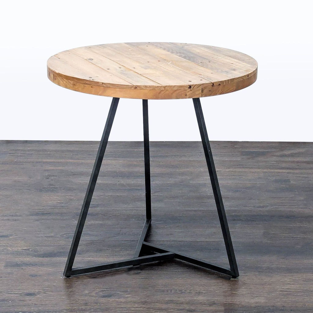 Modern West Elm table with rustic reclaimed pine surface and industrial metal support.