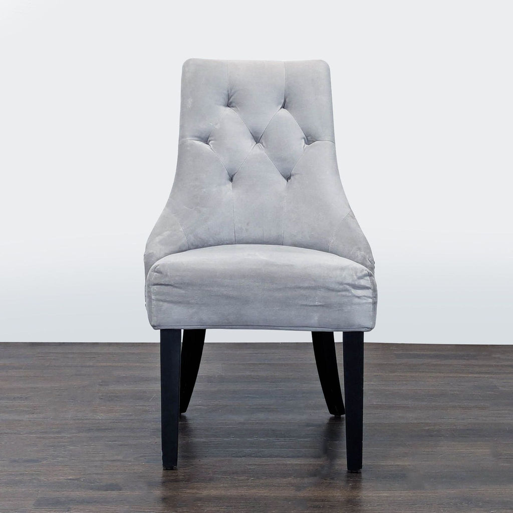 1. Modern World Market dining chair with a curved backrest and slim wooden legs.  