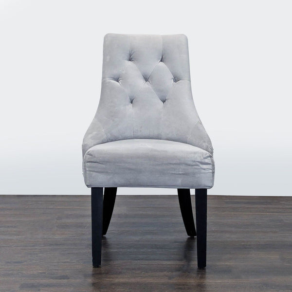 1. Modern World Market dining chair with a curved backrest and slim wooden legs.  
