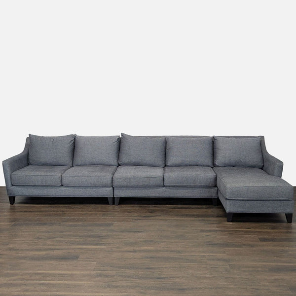 Gray sectional sofa with right-facing chaise, seating five, featuring plush cushions and modern design.