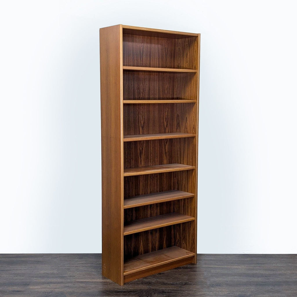 Angled view showing the Scandinavian Designs bookshelf’s rich wood grain, spacious six shelves, and slim profile.