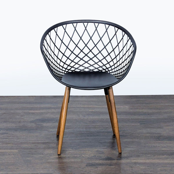 Modern Scandinavian dining chair by CB2 with a black woven plastic seat and light brown ash wood legs.