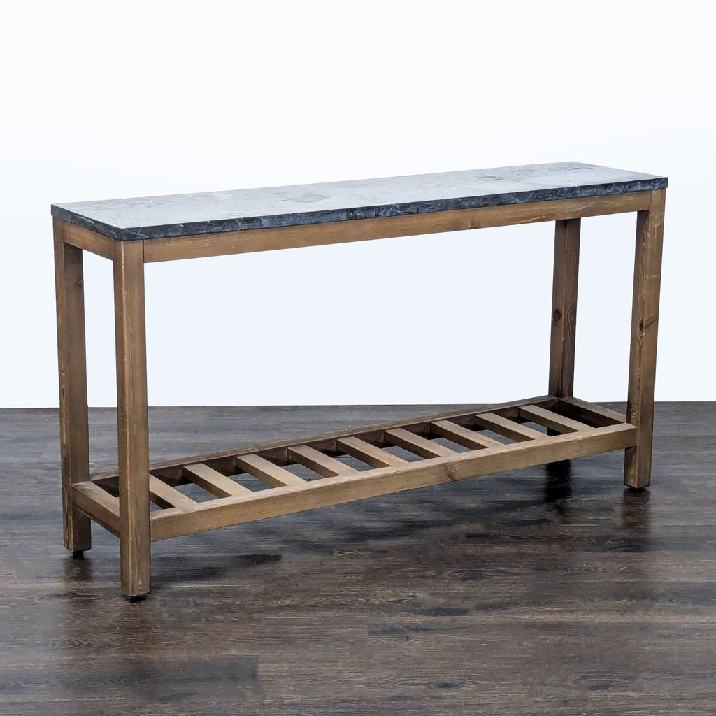1. Pottery Barn side and console table with a stone top and wooden slatted lower shelf, shown on dark flooring.  