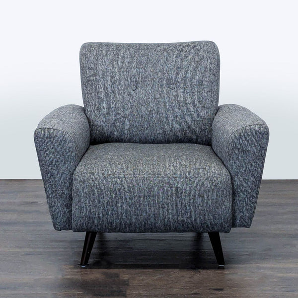 Grey lounge chair with padded seat and sturdy legs, ideal for relaxing in modern living spaces.