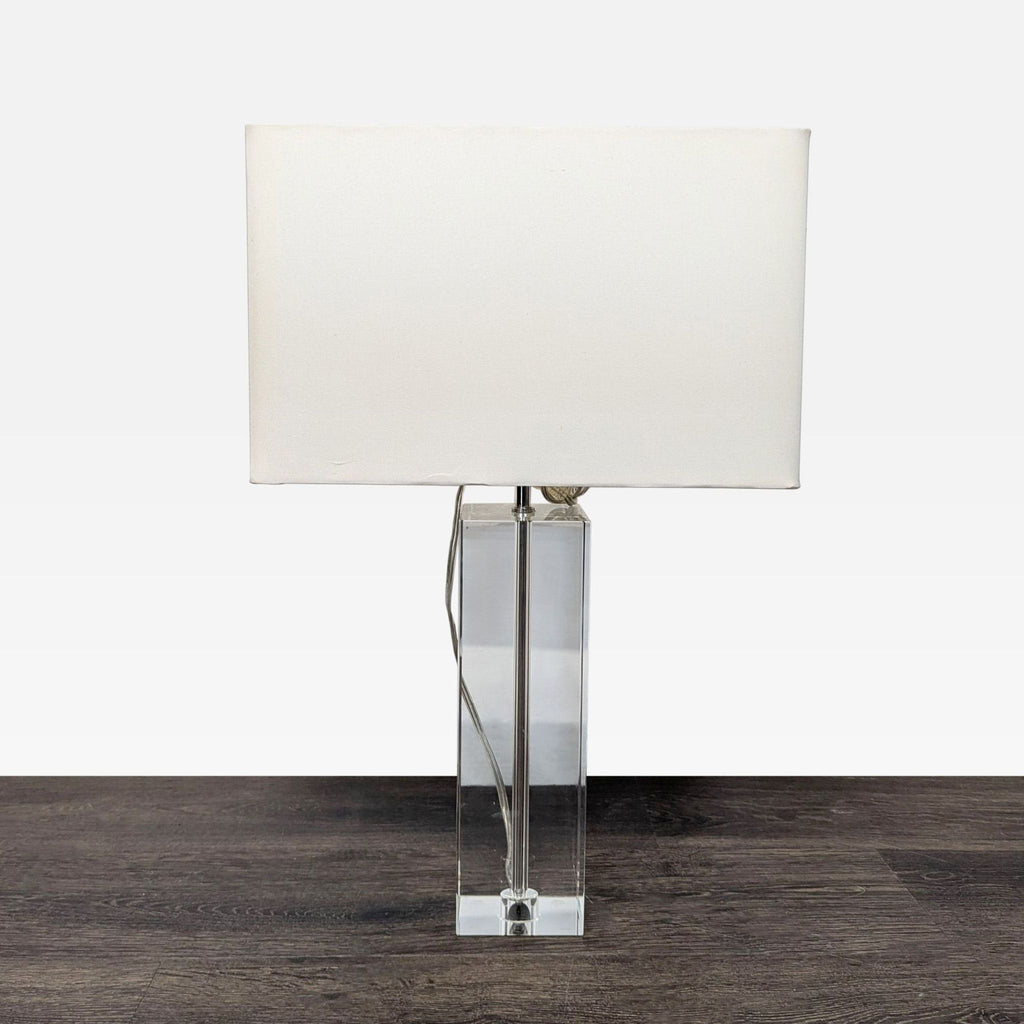 Modern table lamp with a clear lead crystal base and white rectangular shade by Room & Board.