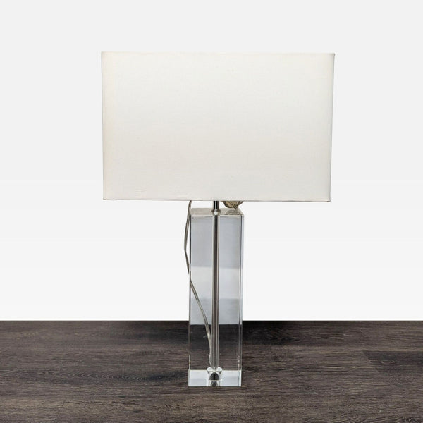 Modern table lamp with a clear lead crystal base and white rectangular shade by Room & Board.