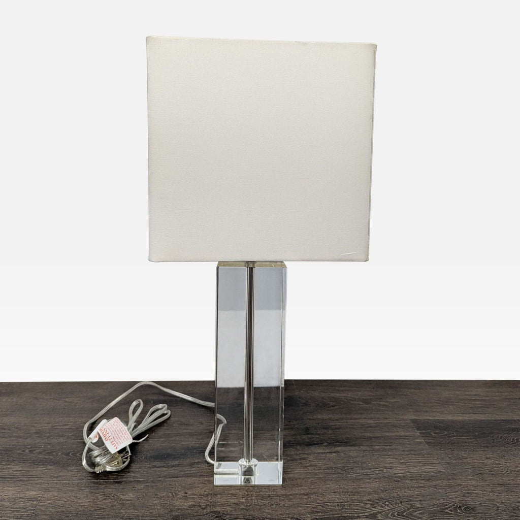 Room & Board minimalist table lamp featuring a sleek crystal base and simple white shade for versatile lighting.