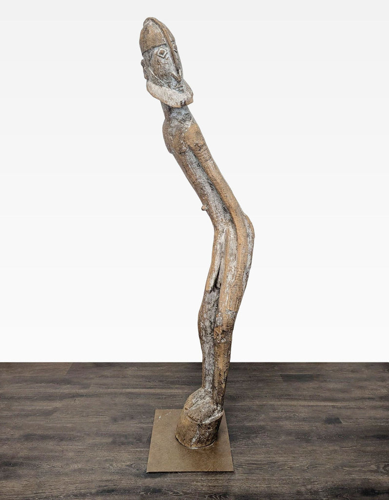 Hand-carved wooden sculpture of a tall, bearded figure on a square metal base with rustic finish.