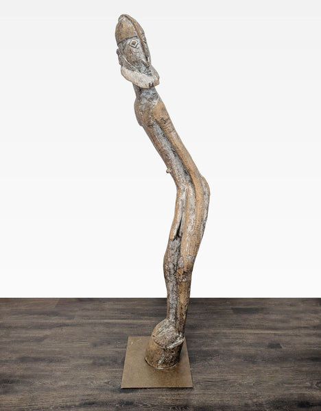 Hand-carved wooden sculpture of a tall, bearded figure on a square metal base with rustic finish.