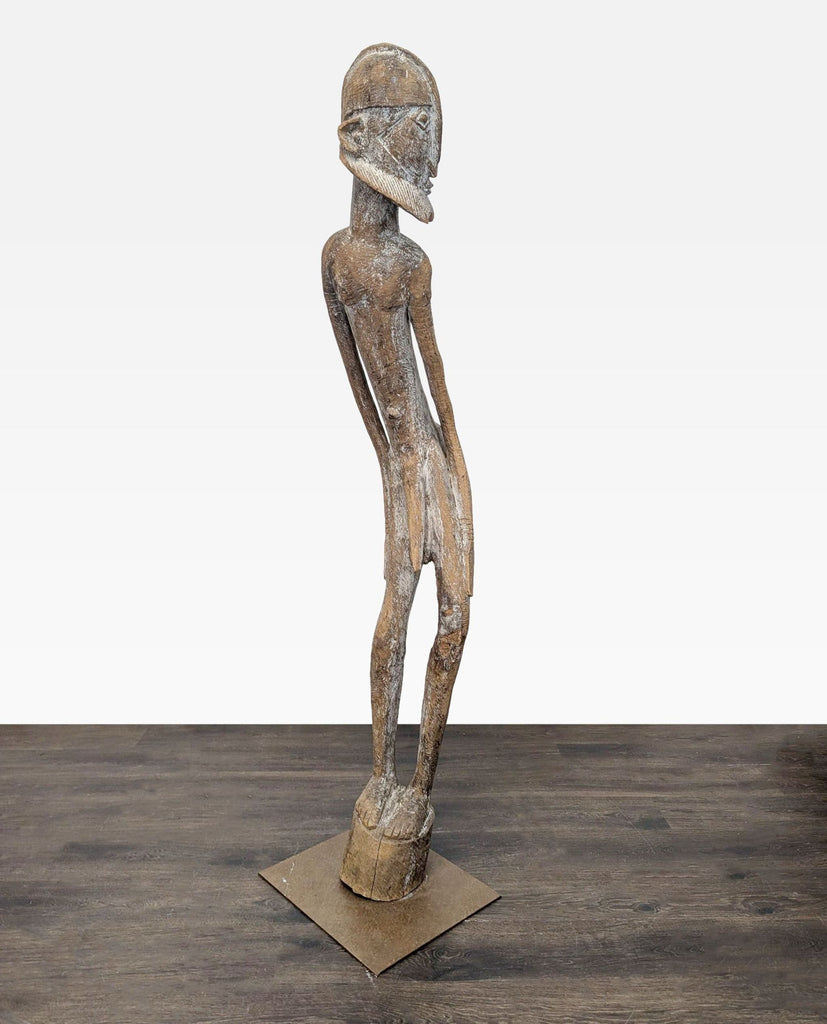 Tall, slim wooden figure with detailed face and beard, mounted on a metal base, ideal for decor.