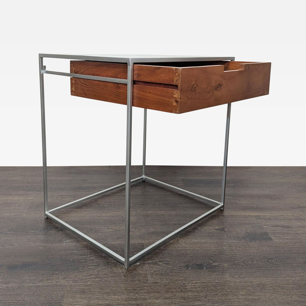CB2 end table with a wooden drawer set on a sturdy, minimalist metal frame.  
