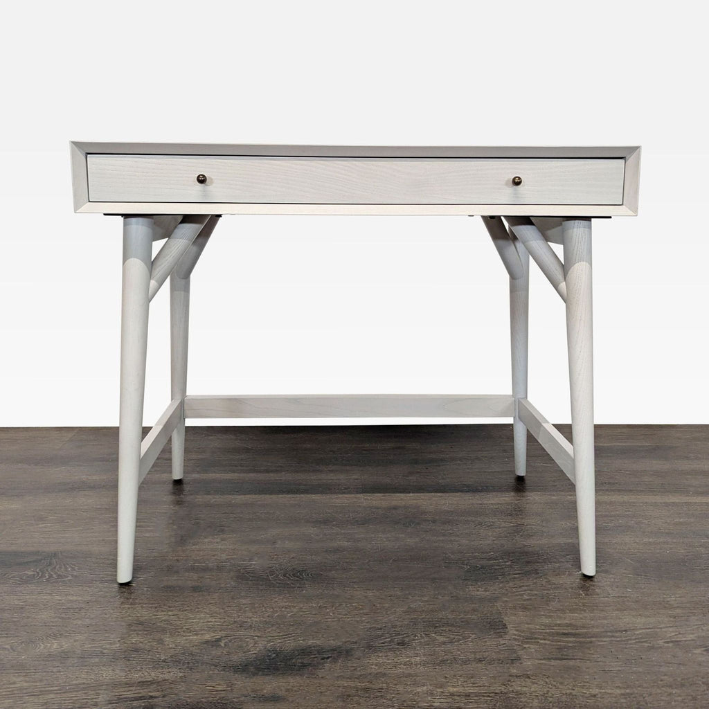 Sleek West Elm desk with a single drawer, wood frame, and modern design, perfect for compact home offices.