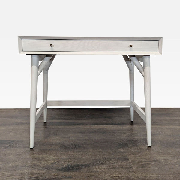 Sleek West Elm desk with wooden frame, single drawer, and modern design, perfect for small home offices.  