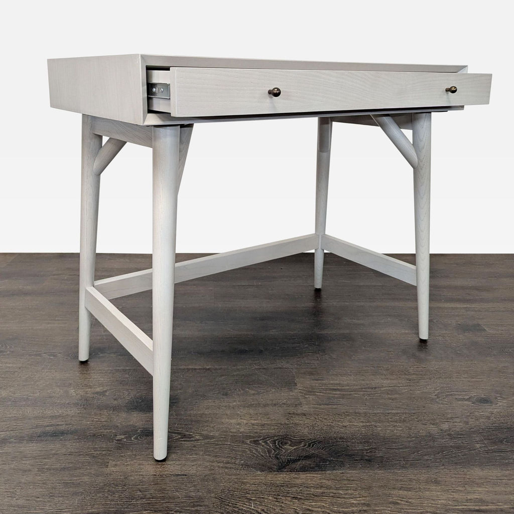 Modern West Elm desk featuring a spacious drawer and sturdy wood frame, ideal for small workspaces or studies.
