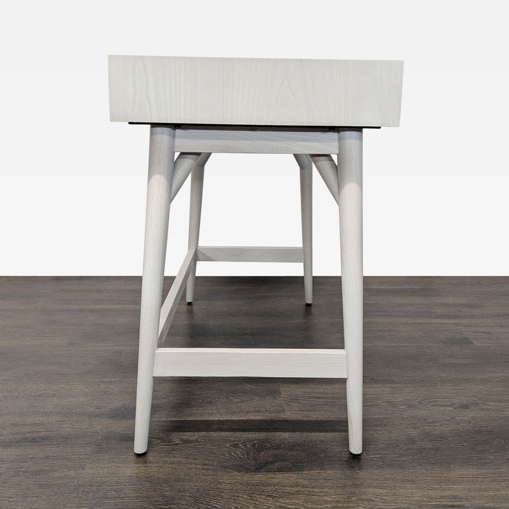 Compact West Elm desk in a minimalist style, offering smooth finish, storage drawer, and versatile home decor fit.