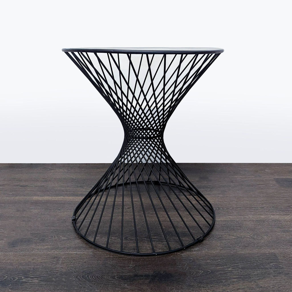 Stylish black metal end table with a unique hourglass design, suitable for various spaces and easy to move.