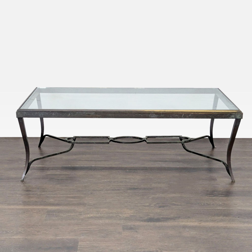 Hollywood Regency coffee table by Carole Gratale with a glass top and patinaed iron cabriole legs.