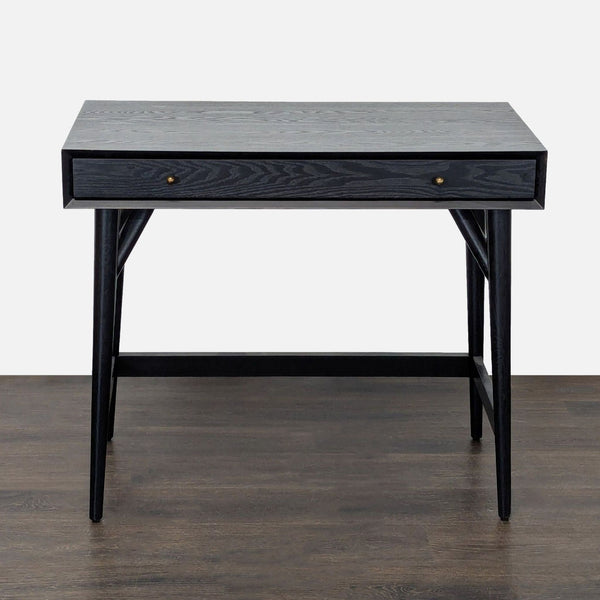 Minimalist black wooden West Elm desk with spacious top, pull-out drawer, and sturdy legs for home or office use.