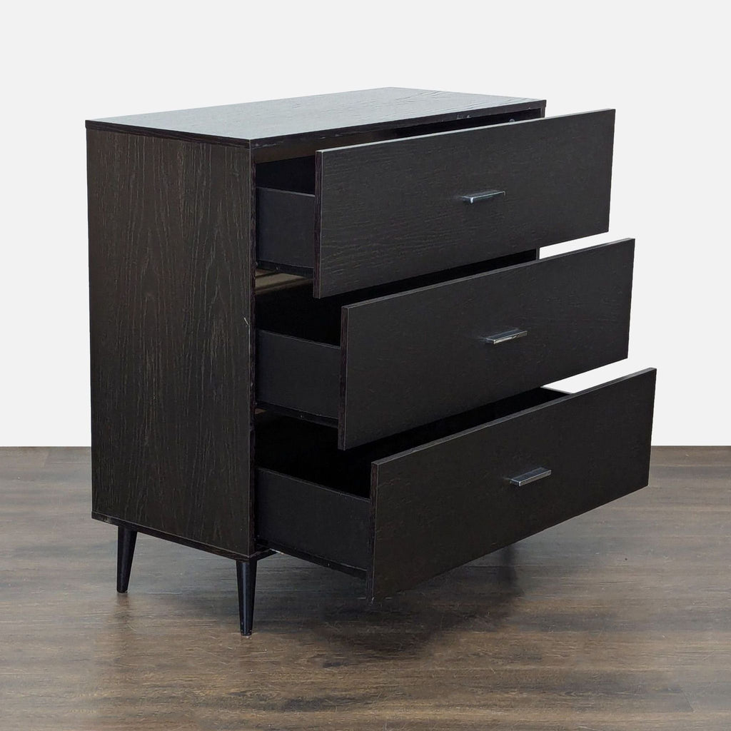 Modern West Elm dresser featuring sleek dark wood, three roomy drawers, and simple metal handles on sturdy legs.