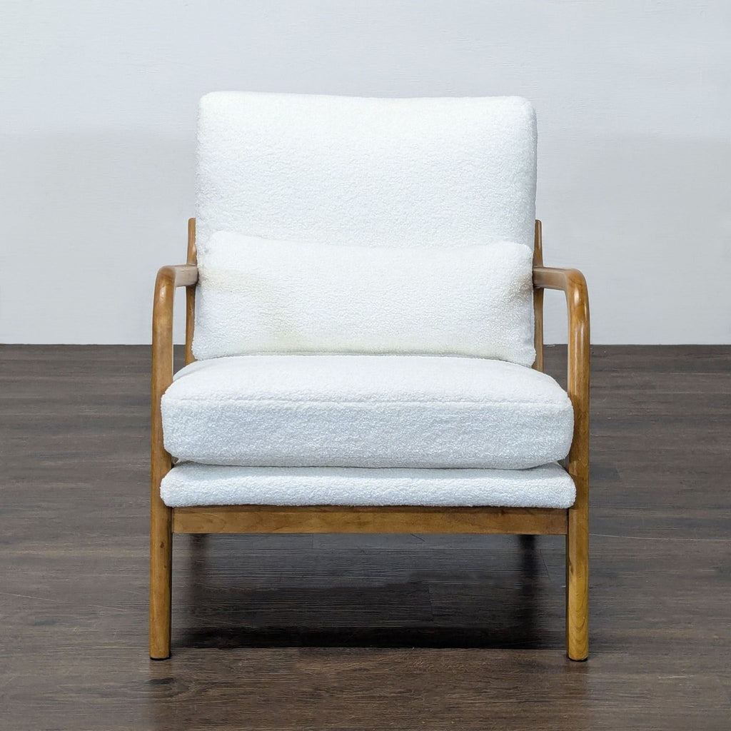 Lounge chair with a wooden frame and white boucle cushions, featuring curved armrests and plush back support.  