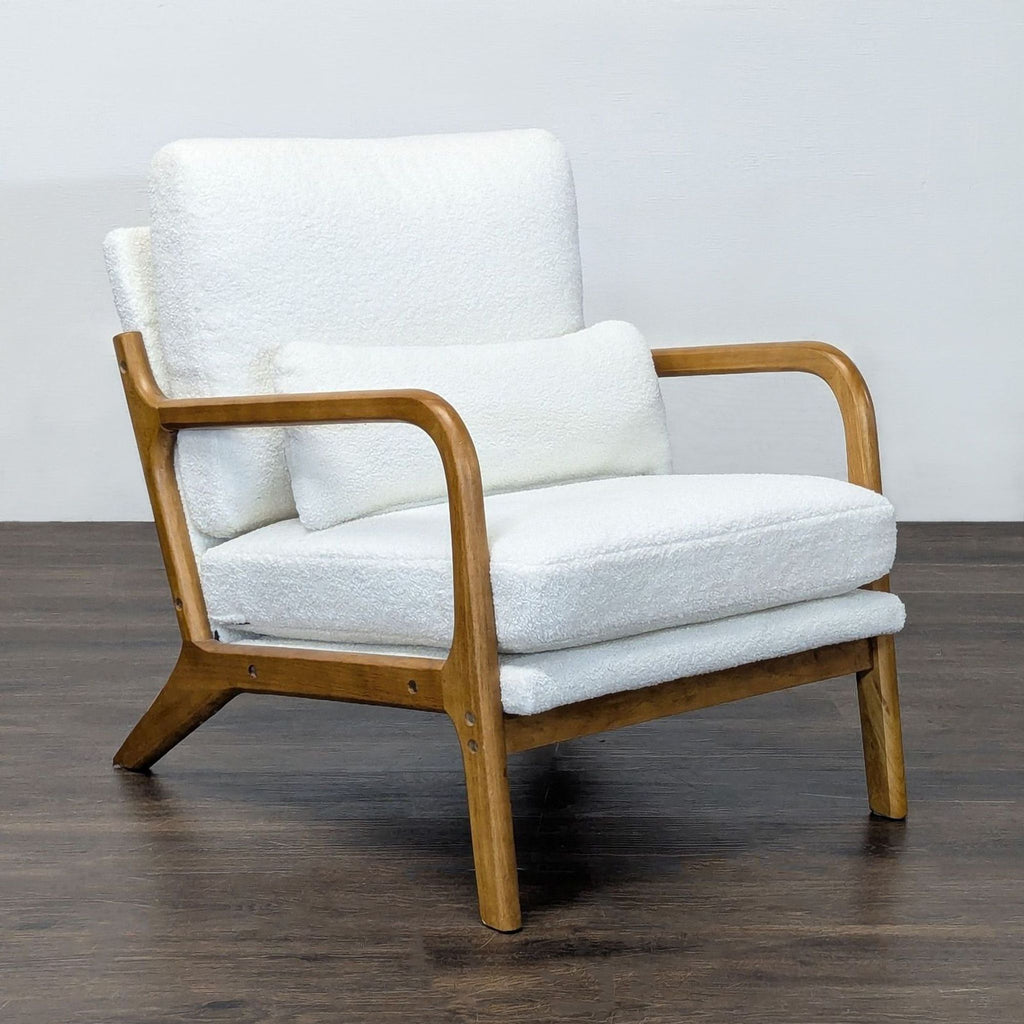 Modern lounge chair with soft white fabric cushions and sturdy wood construction, ideal for relaxing in style.  