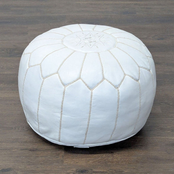 Handmade pouf with detailed embroidery, shown with a removable leather cover for easy cleaning.  