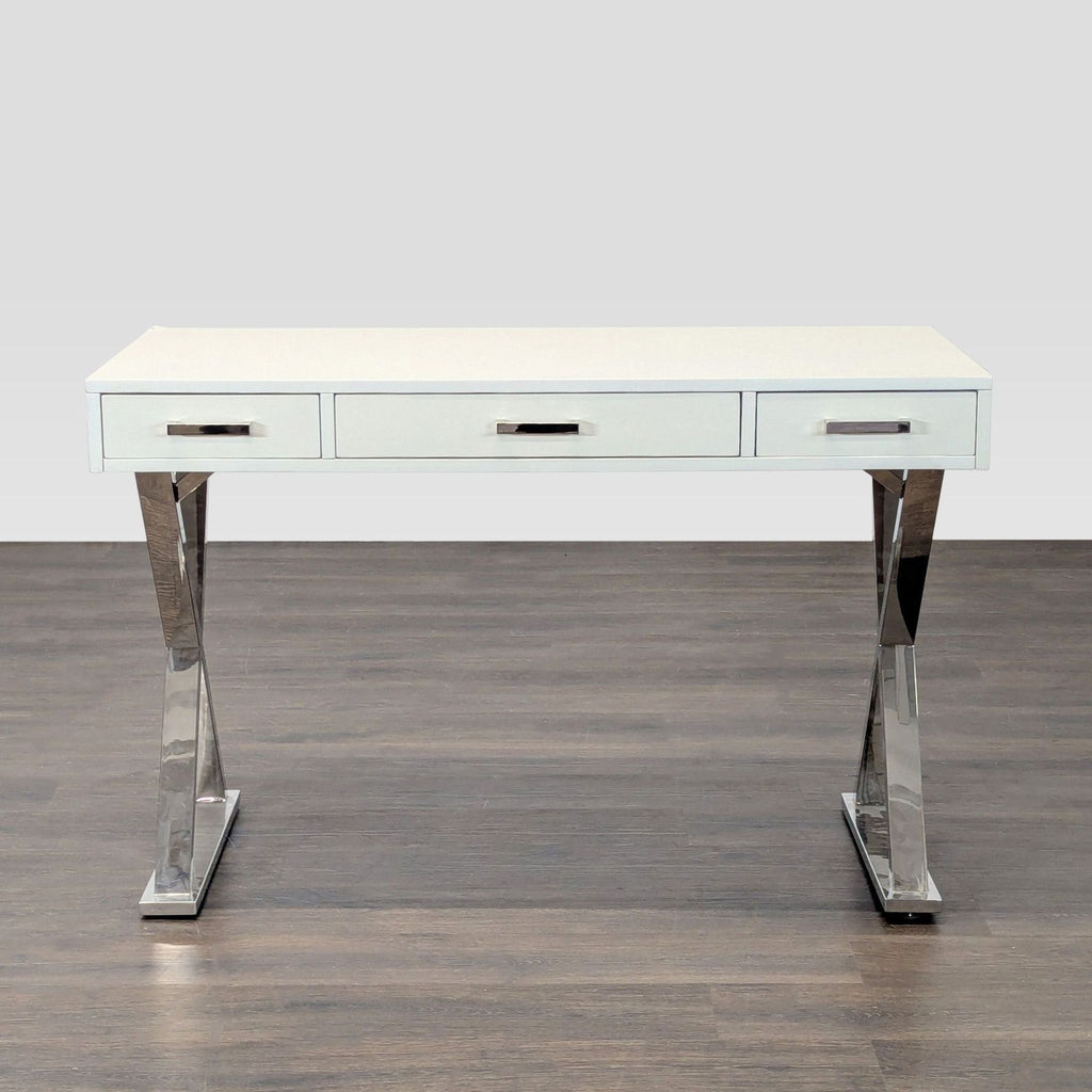 Modern white Pottery Barn desk with chrome legs and three drawers, ideal for stylish home or office spaces.