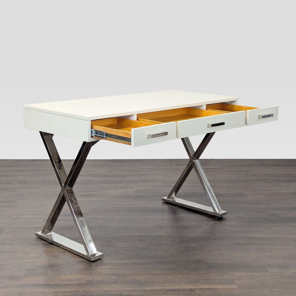 Sleek contemporary desk from Pottery Barn in white, featuring chrome legs and three storage drawers.