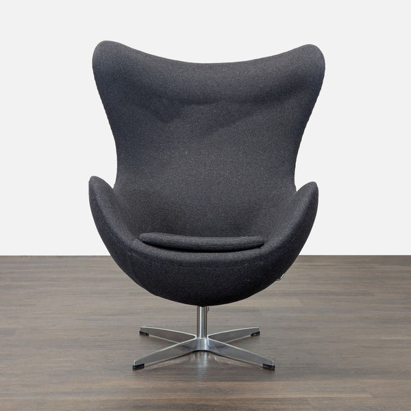 Modern egg-shaped lounge chair in dark grey fabric with high back and metal swivel base.