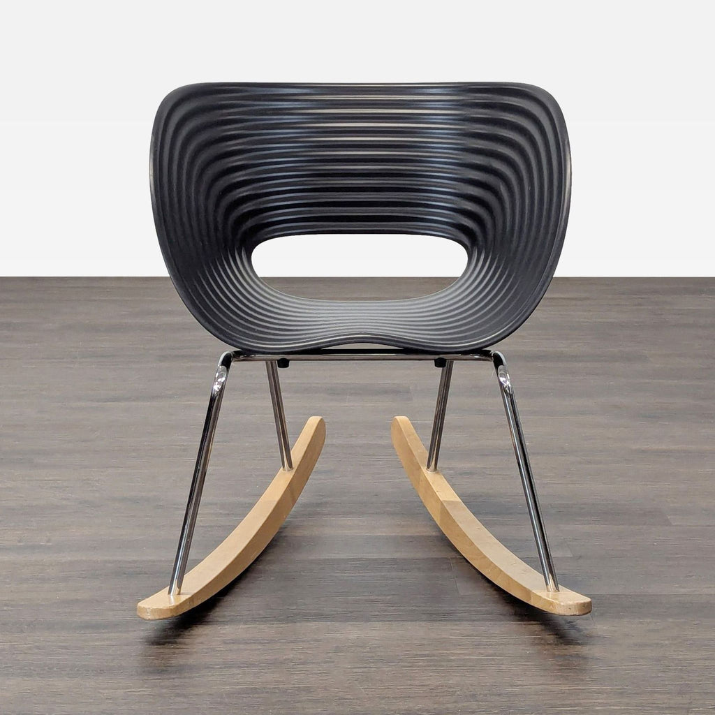 Vitra lounge rocker with black contoured seat, chrome frame, and wooden rockers for modern comfort.  