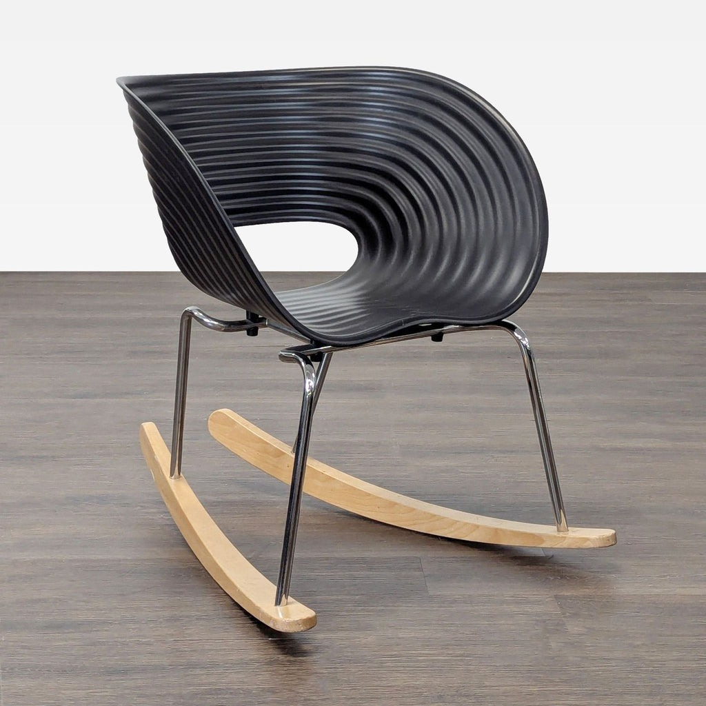 Modern black Vitra rocking chair featuring a grooved seat, chrome legs, and smooth wooden rocker base.  