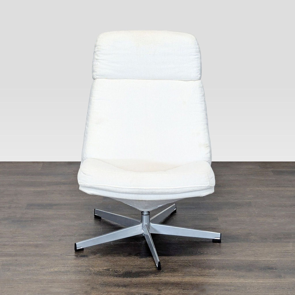 White padded Ikea lounge chair with a metal swivel base, suitable for relaxing in a living room setting.