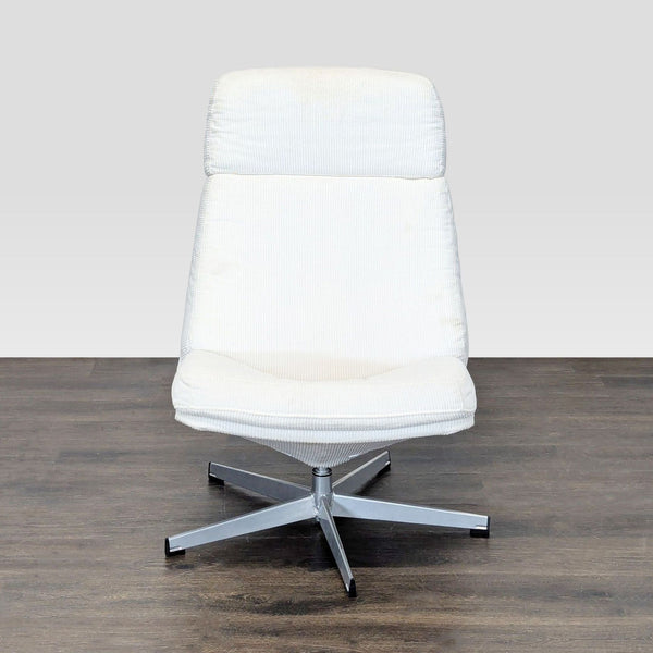 White padded Ikea lounge chair with a metal swivel base, suitable for relaxing in a living room setting.