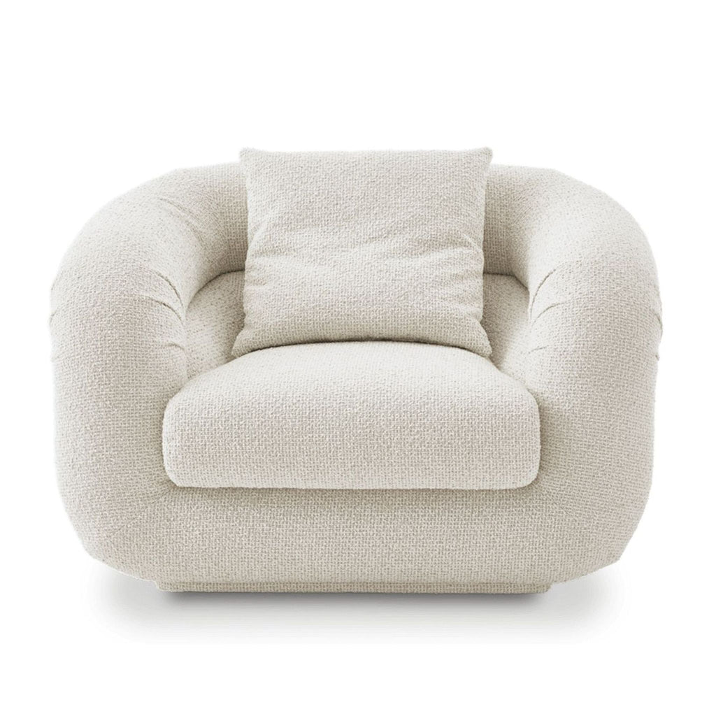 Cream bouclé Castlery lounge chair with plush cushion, rounded shape, and modern design for cozy living spaces.