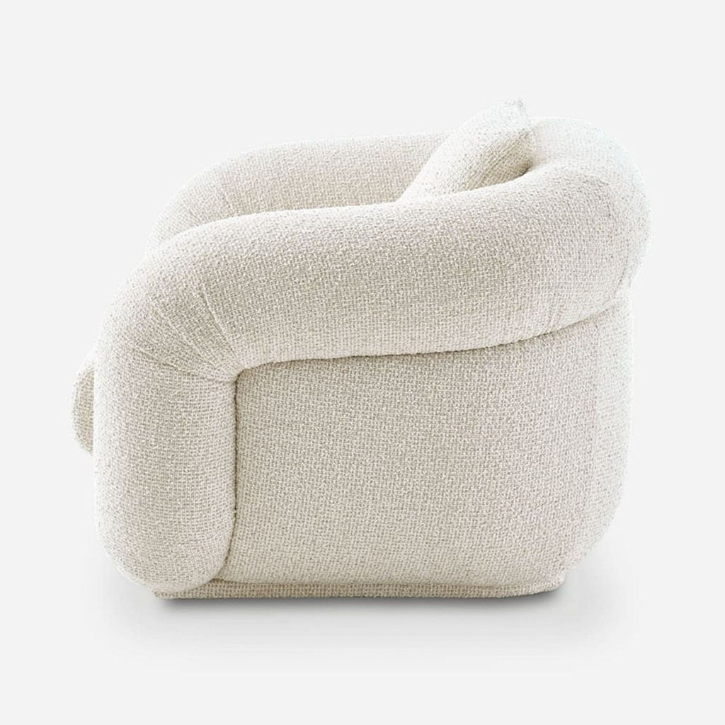 Rounded Castlery lounge chair in cream bouclé fabric, designed for comfort and style in any lounge area.