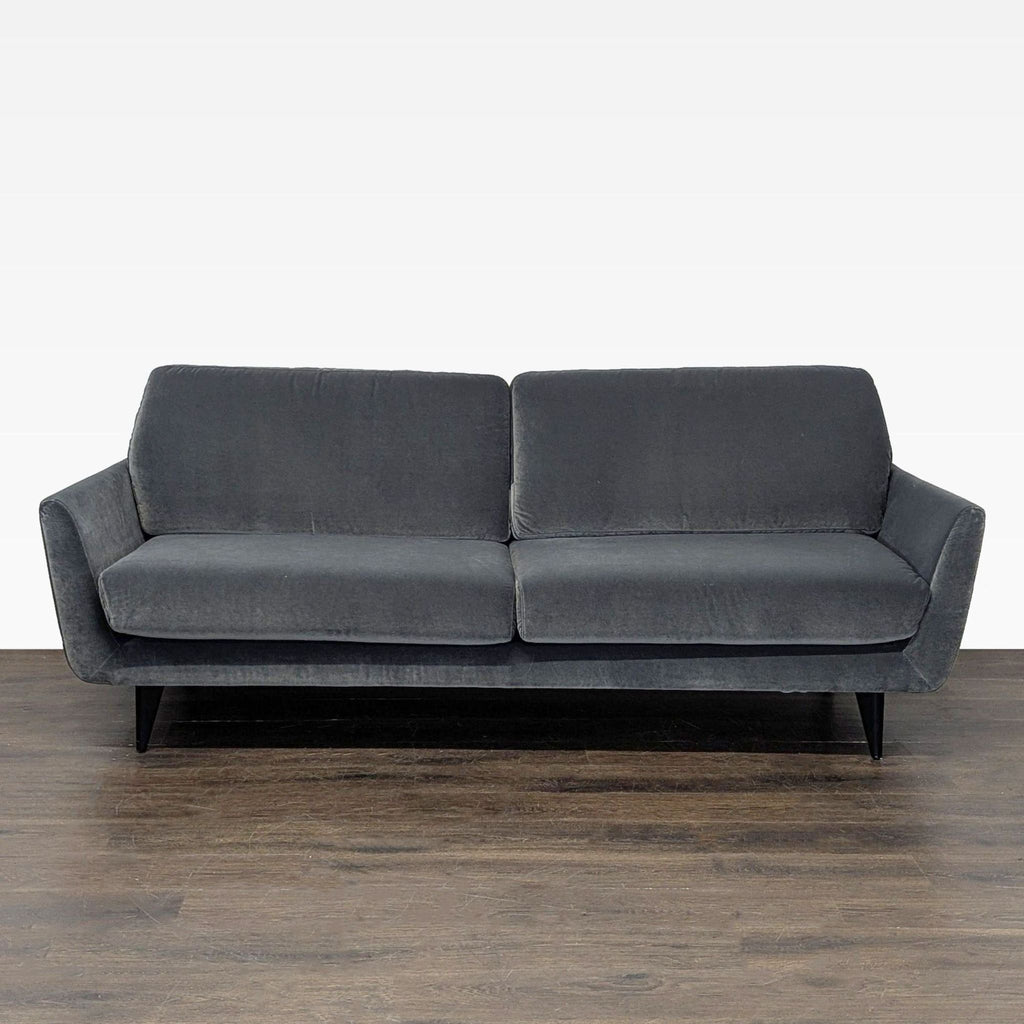 Sits For Crate And Barrel 3-seat sofa with dark gray fabric, plush cushions, and sleek black legs.